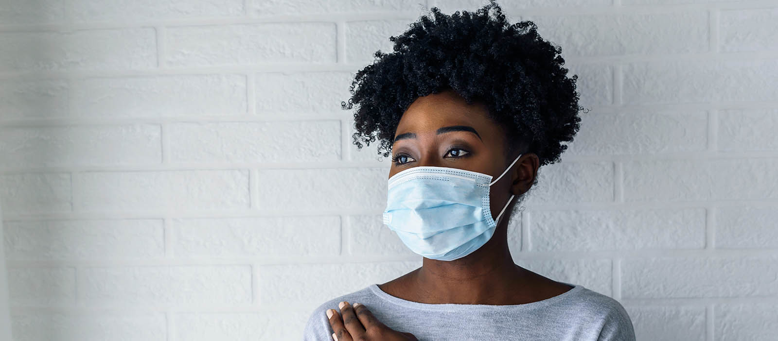 Portrait of young woman wearing disposable medi